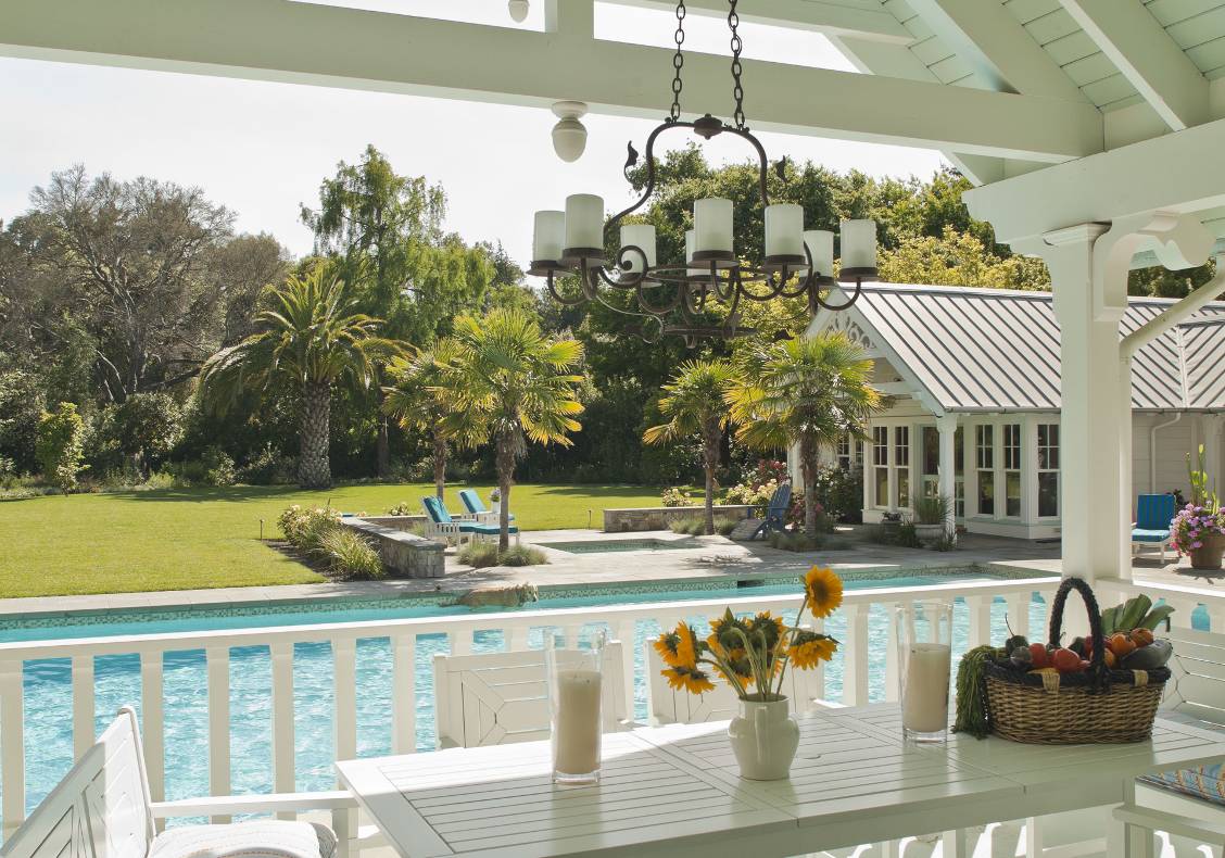 Scroll details frame this view across the pool to the spa and great expanse of lawn.