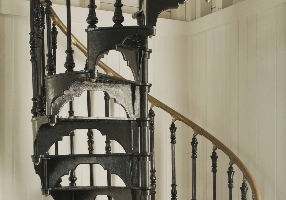 A victorian cast iron staircase leads to an overlook room in the tower.