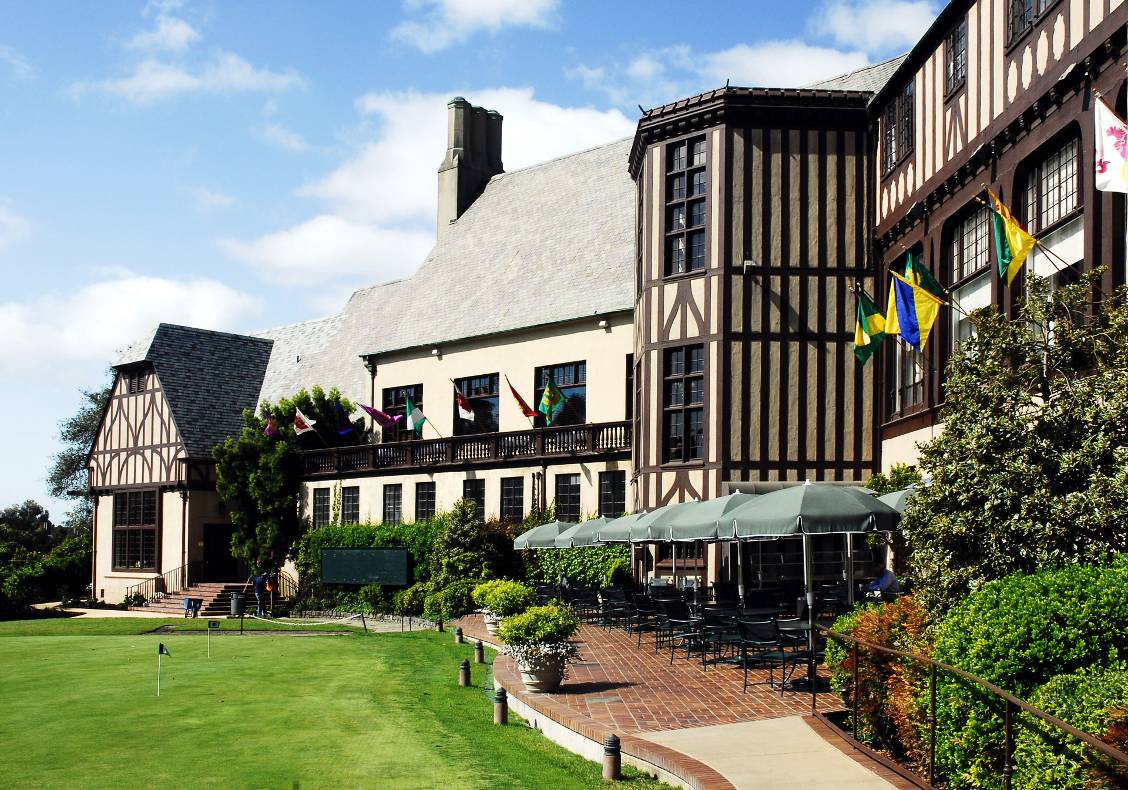 The brick-paved patio with its meandering pathway, as well as the imposing half-timbered tower element, are features of variety and interest in the rear elevation of the country club.