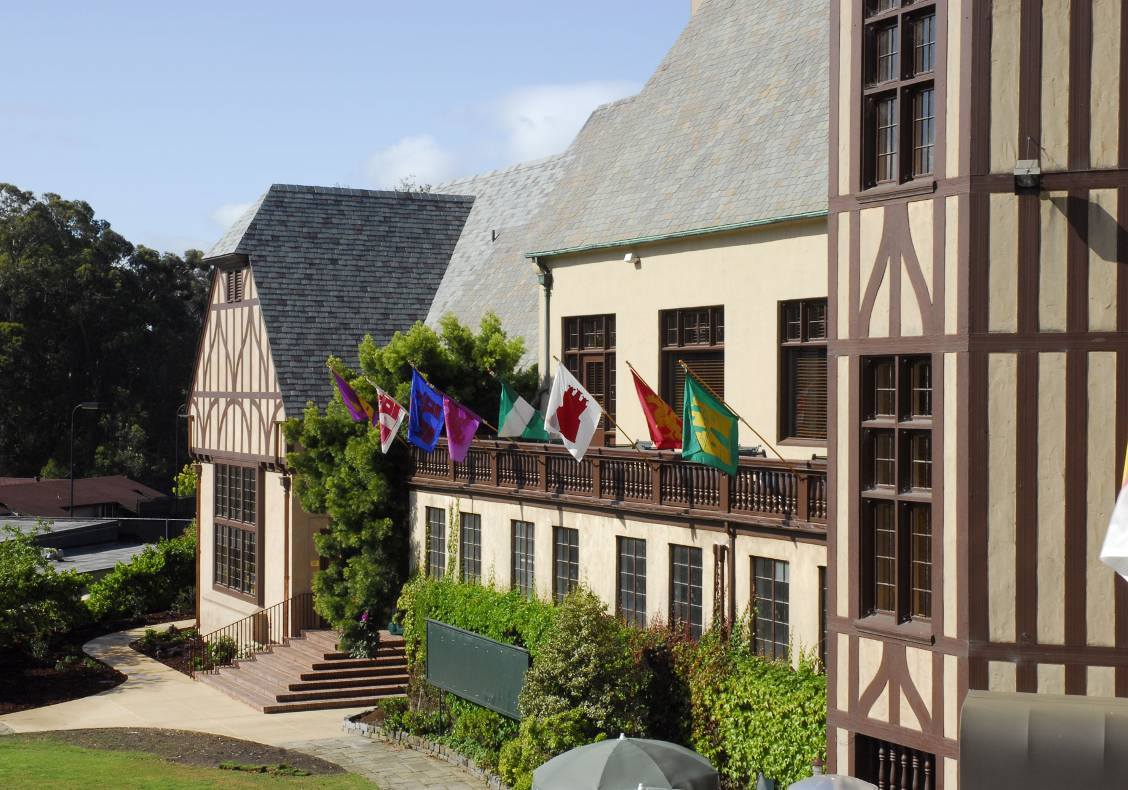 Colorful flags with old-time coats of arms decorate the rear wooden balconies of the country club, whose ivy-covered, half-timbered exterior recalls the great Tudor estates and outdoor sport traditions of England.
