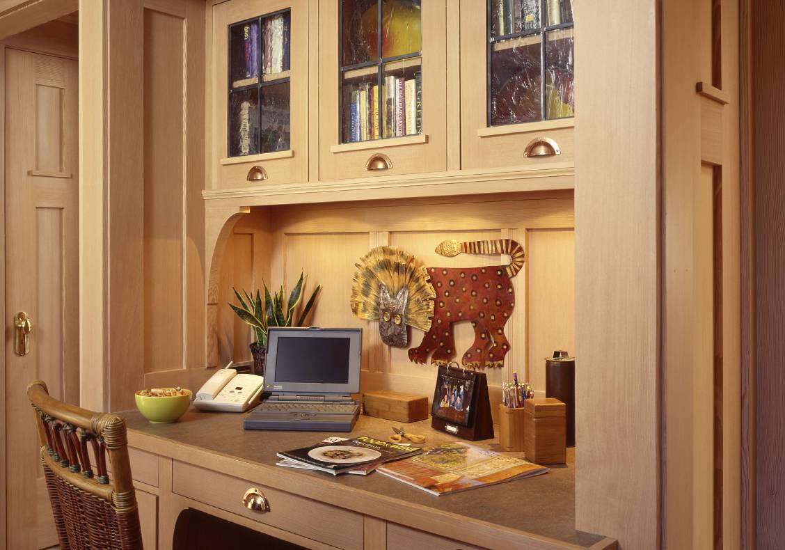 Custom built in desk with wood detailing and copper bin pulls in keeping with the Arts and Crafts aesthetic.