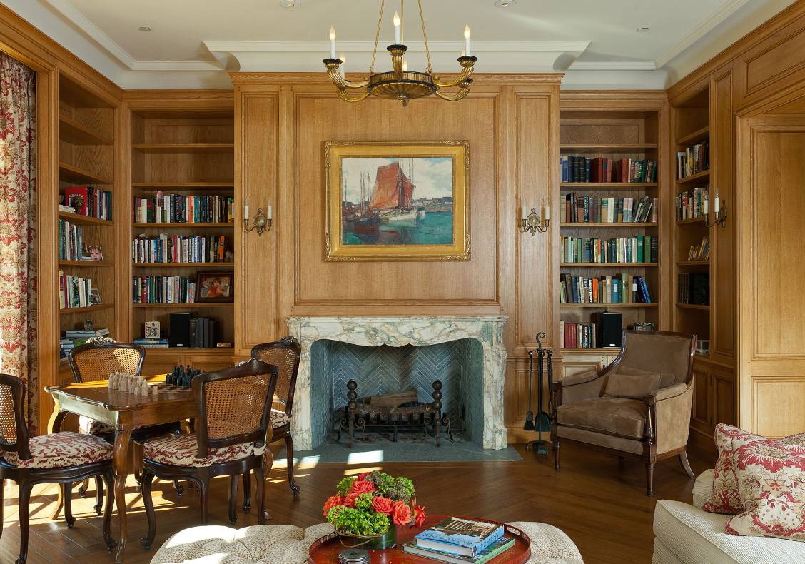 The rooms off the hall have distinctive ceiling forms and extend the exterior’s Gallic themes with parquet de Versailles, antique fireplaces, and other interior flourishes.