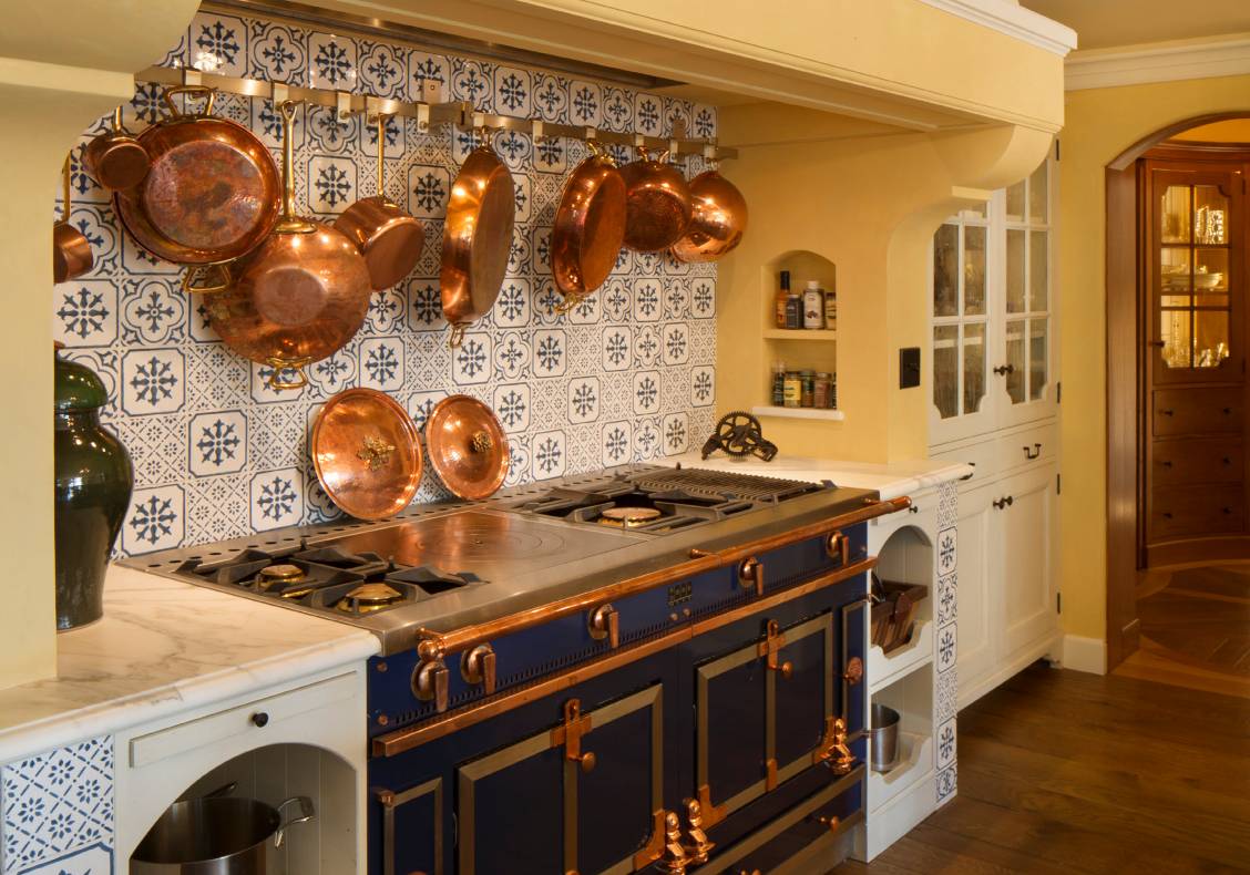 The classic range backs up to a tiled wall inspired by one at Monet's house in Giverny.