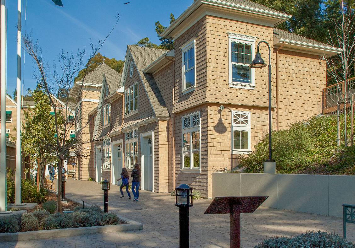A double gambrel roof, elliptical front entry window, square columns and green awnings to shade the sun are only a few unique features of the upper school building.