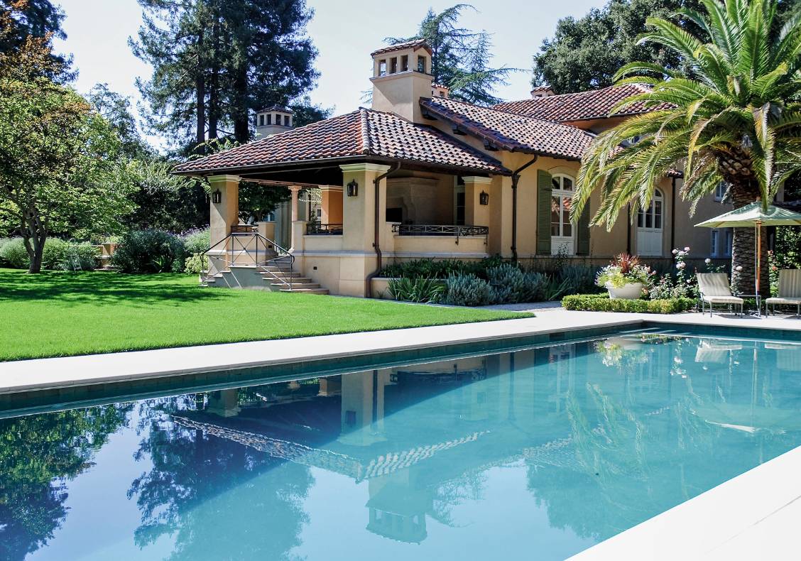 The outdoor loggia surveys the rear lawn and pool.