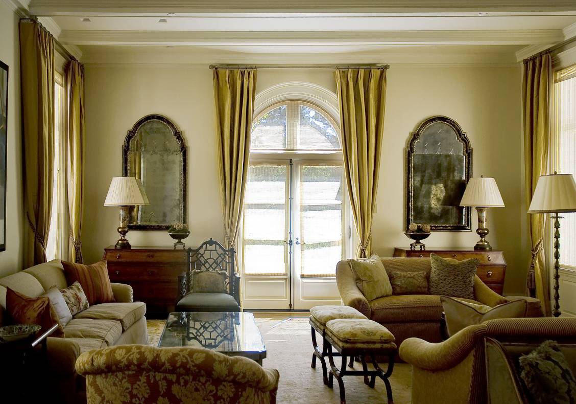 The living room maintains the symmetry and classical detailing of the house's facades.