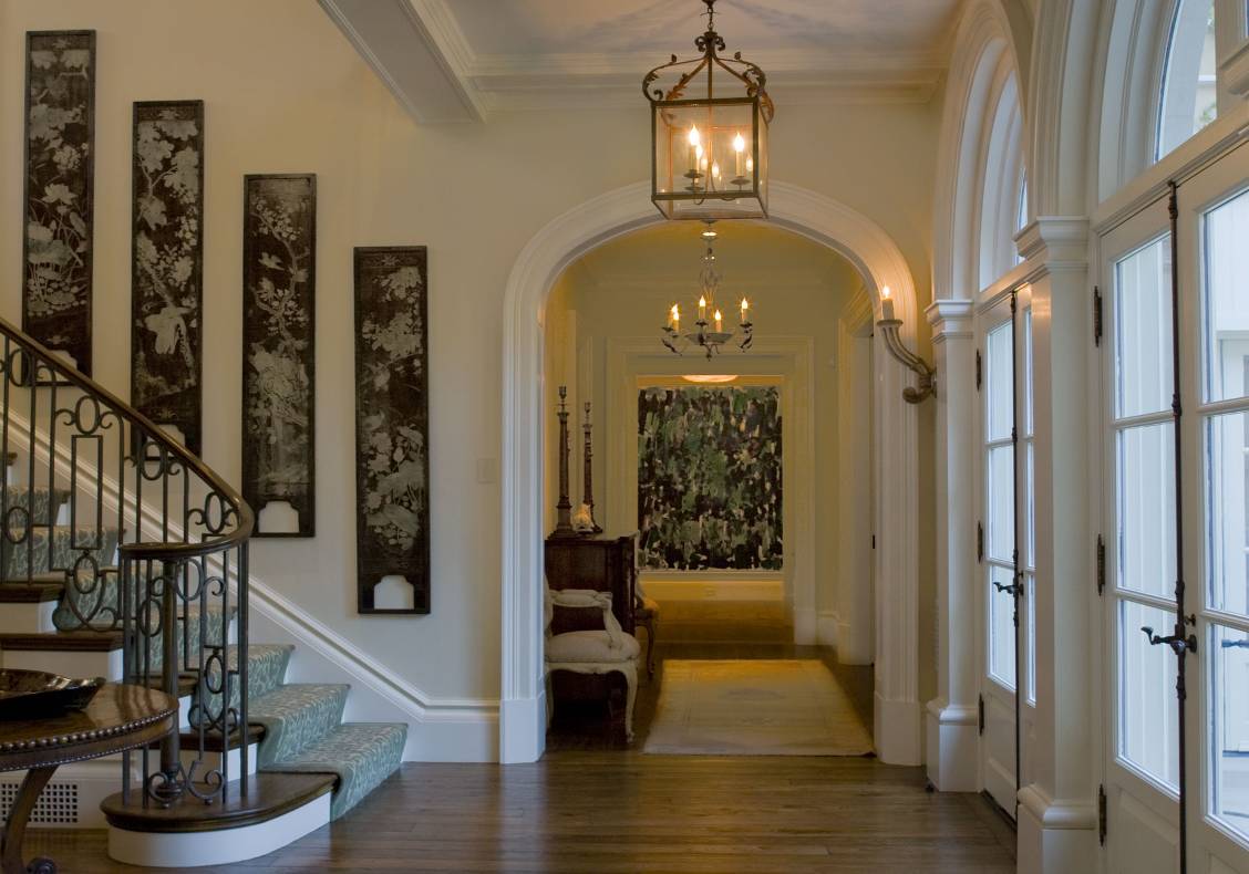 The entry hall leads to a fountain court overlooking the rear gardens.