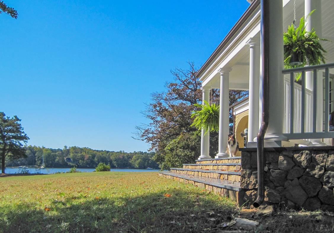A neoclassical portico faces the path leading to the boat dock for the couple’s son’s sailboat.