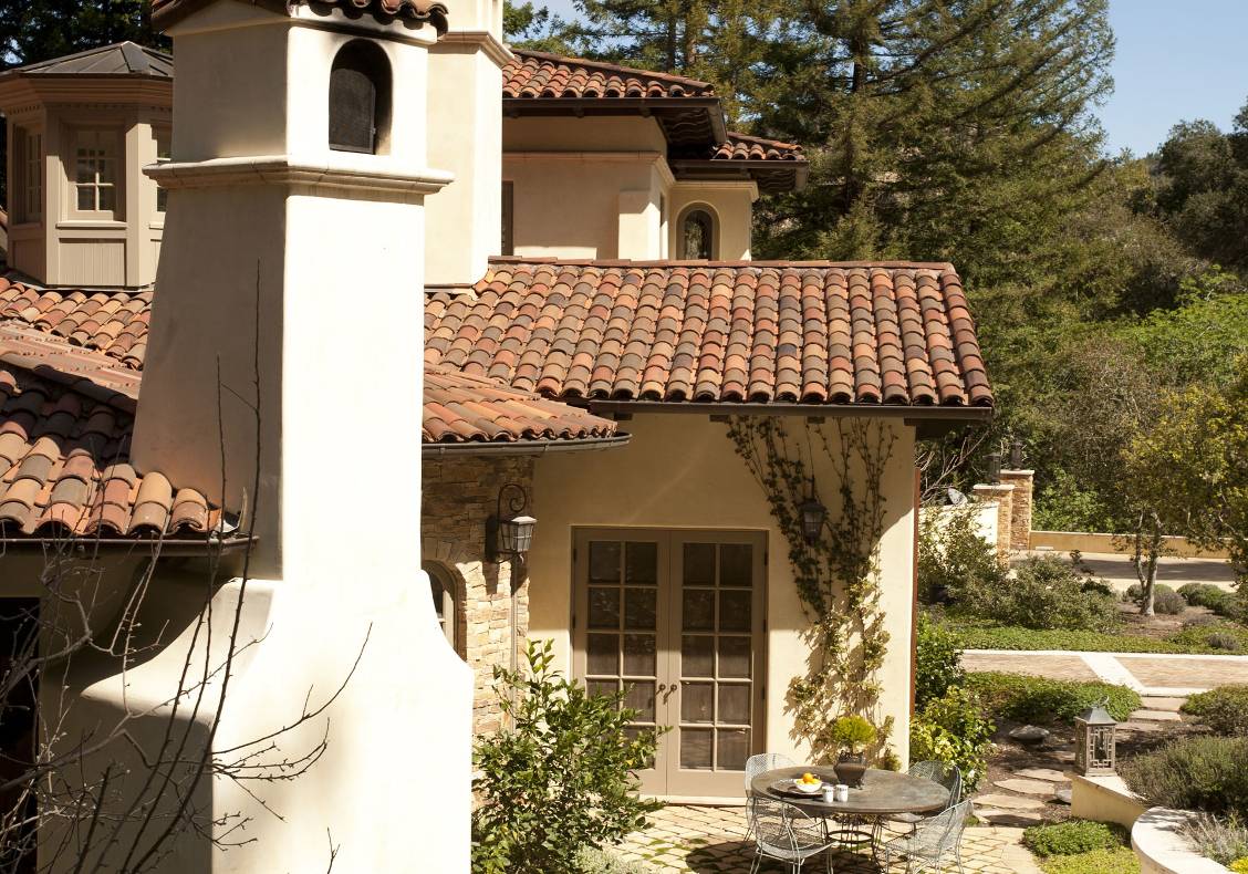 Outside the kitchen an herb garden surrounds a sunny breakfast area.