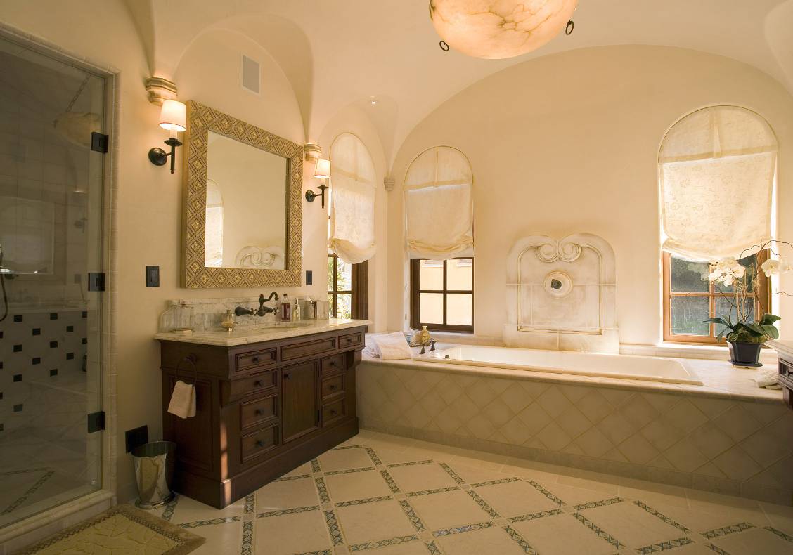 The master bath fixtures are set in warm Calacatta marble counters.