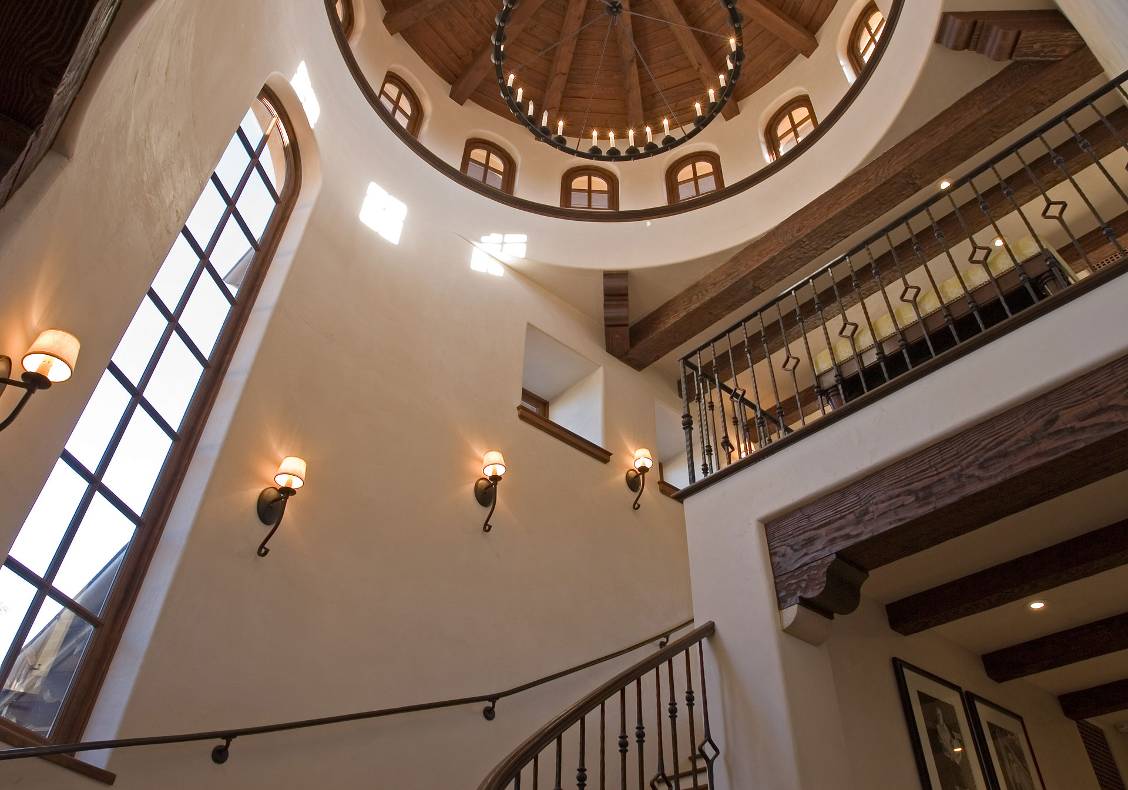 The domed, circular stair tower is pierced by a ring of attic windows.