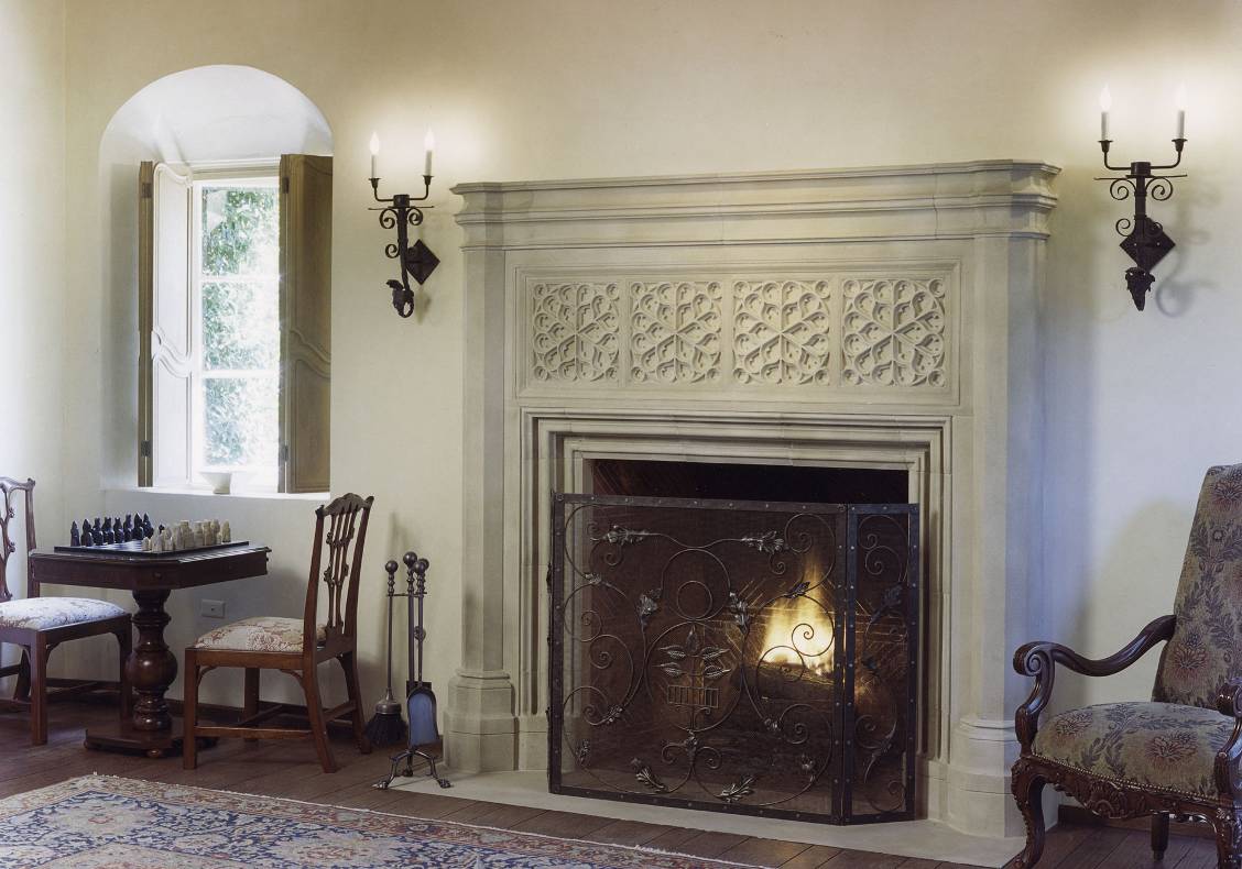 The stone fireplace and deep window alcoves are characteristic of the Spanish colonial style.