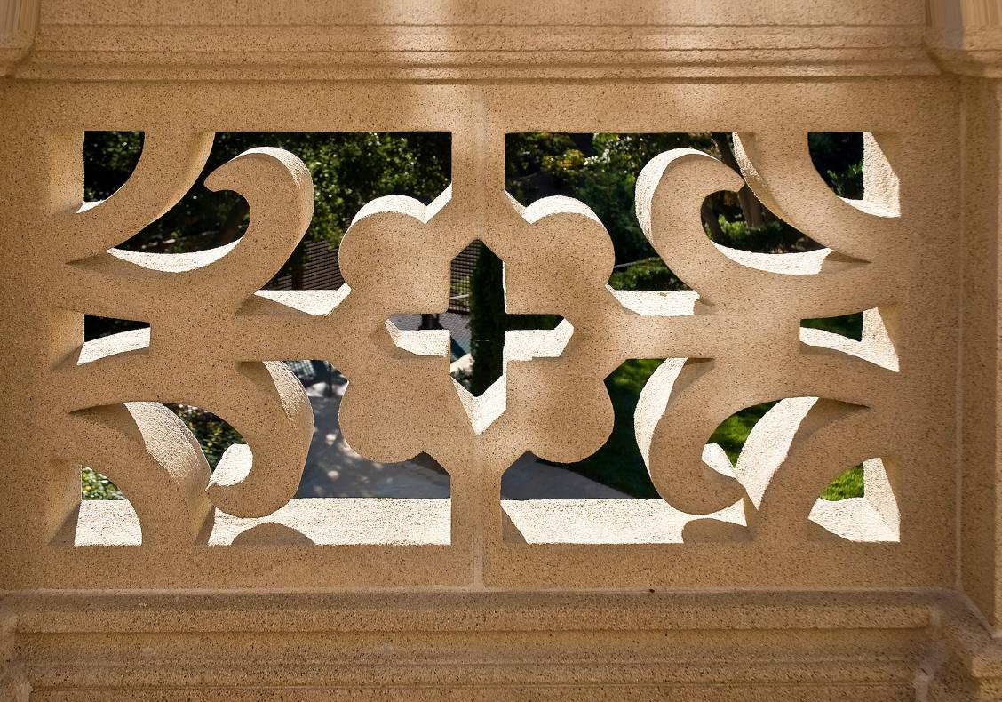 The cast stone railings are based on English country homes' designs of the period which often incorporated exotic Chinese garden screens.