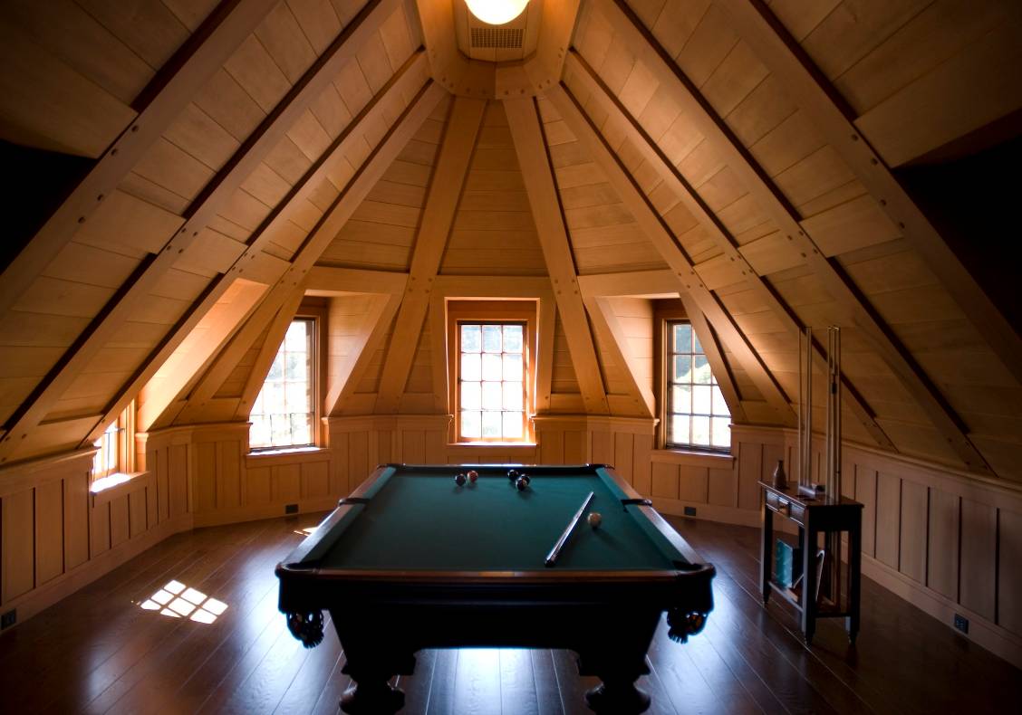 Part of the main house renovations included this striking, wood-paneled, octagonal billiard parlor that allows light from the gables to stream in a way that only adds to the quiet, concentrated atmosphere of a good billiard game.