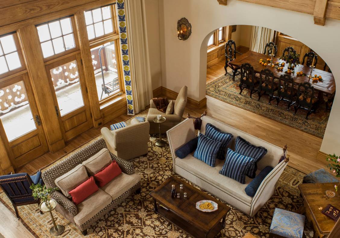 The design is organized around a double-height living room, which provides a grand gathering space around the fireplace and captures a view of the entire mountain through a large window on the south wall.