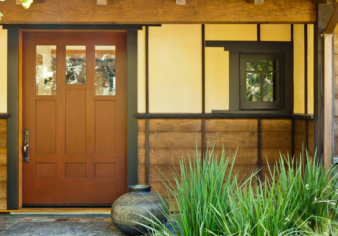 The red lacquered front door opens onto a variegated slate foyer that overlooks the courtyard.