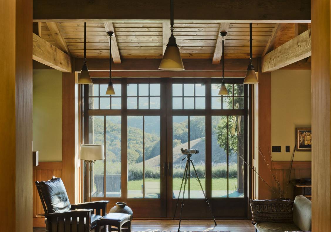 Custom-designed wood doors that slide into the walls. Stained wood ceiling and hickory/pecan flat-sawn hardwood floors, slightly distressed.