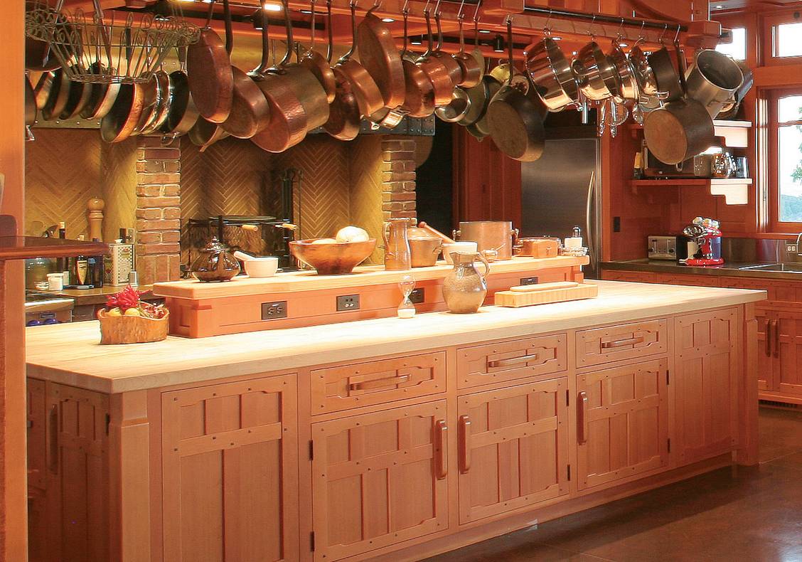 The kitchen was designed for the owners who are well known chefs and features a large work island with a generous heavy timber pot rack above and a separate cooking hearth for spit roasting.
