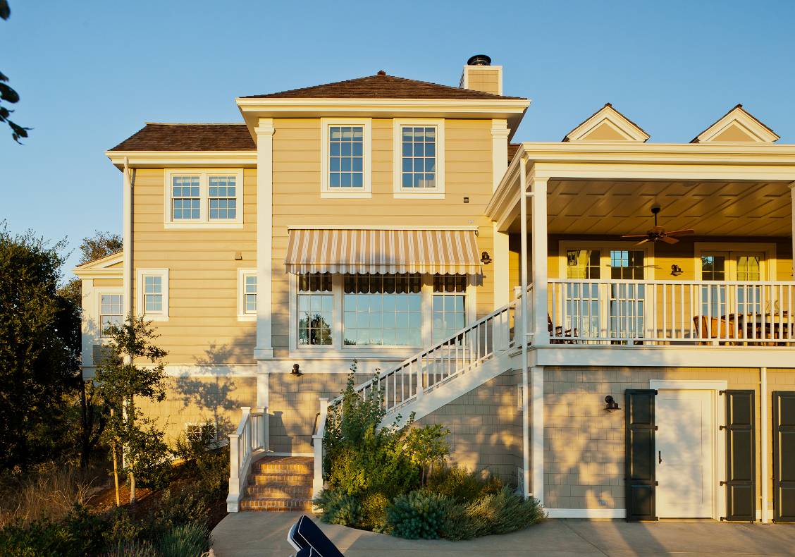 It is a classic California farm house, with painted wood pilasters, tall double hung windows, gabled dormers, and a Greek revival front porch.