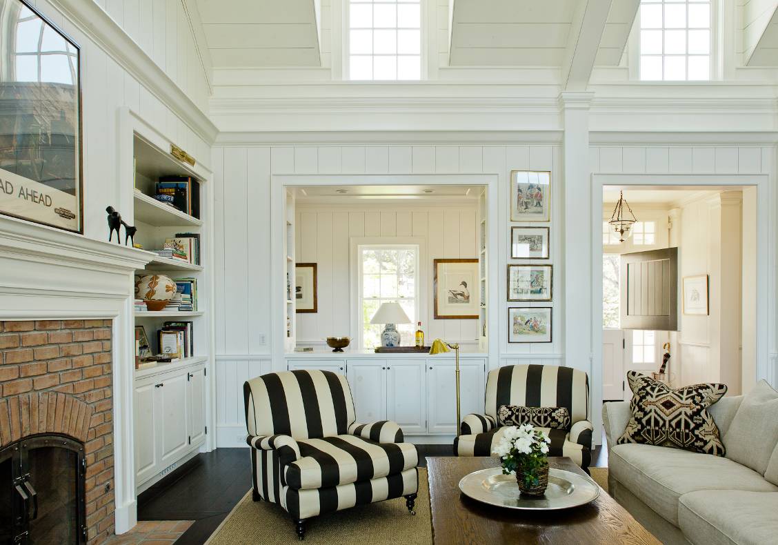 The main room is a gabled space with clerestory dormer windows and painted wood paneling.